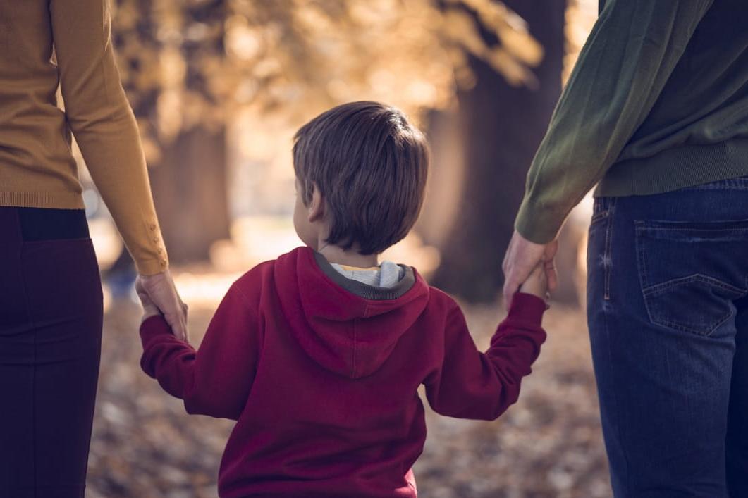 child holding adult's hands